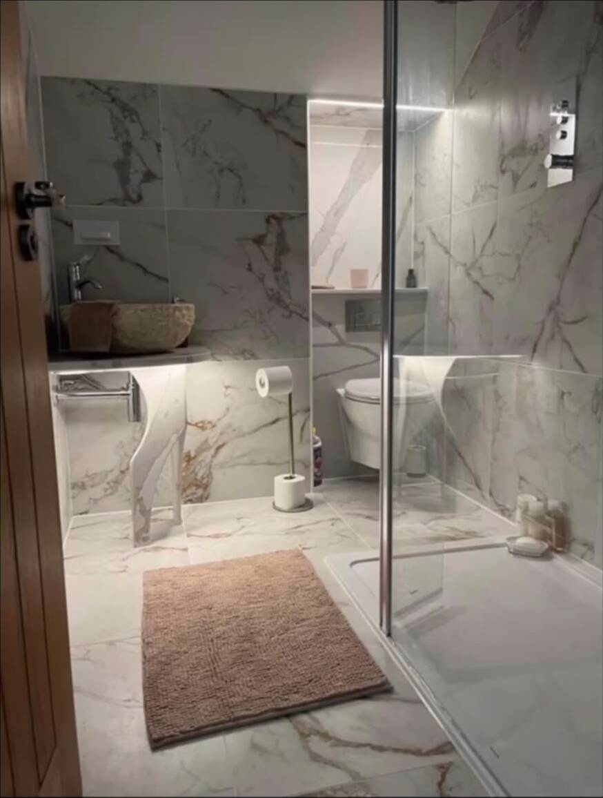 Marble-tiled bathroom renovation by Barnett's Bespoke